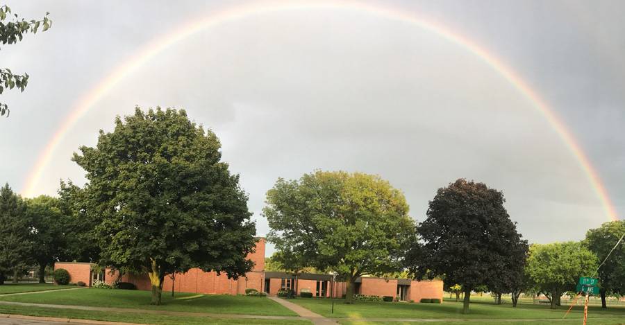 Exterior image of Memorial Lutheran Church with a full rainbow above